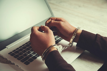 man hand handcuffs on keyboard