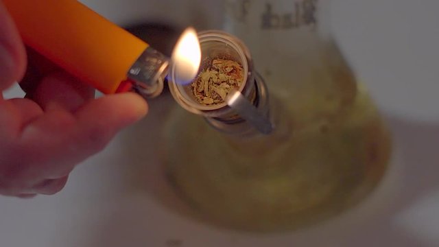 Smoking medical marijuana through the bong close-up .Medical marijuana, and legalization around the world slowmotion