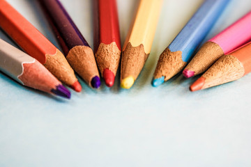 Beautiful bright colored wooden colored sharpening pencils for drawing. Flat lay and copy space on blue background