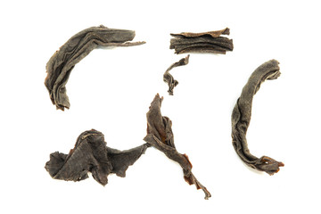 Dry black tea leaves isolated on white background