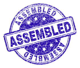 ASSEMBLED stamp seal imprint with distress texture. Designed with rounded rectangles and circles. Blue vector rubber print of ASSEMBLED title with dust texture.