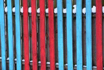red blue wooden texture of fence boards in the snow