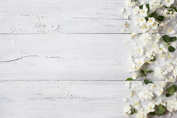 White wooden background with white spring flowers