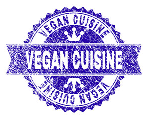 VEGAN CUISINE rosette stamp seal watermark with distress texture. Designed with round rosette, ribbon and small crowns. Blue vector rubber watermark of VEGAN CUISINE caption with dirty texture.