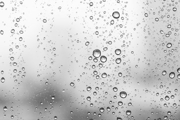 Water drops on glass window white background after the rain in the autumn fall