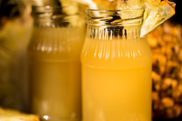 Pineapple juice and slice placed on a wooden table