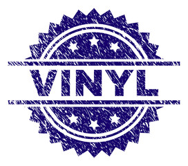 VINYL stamp seal watermark with distress style. Blue vector rubber print of VINYL text with corroded texture.
