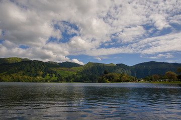 lake, mountains and blue sky with clouds 