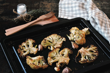 Baked cauliflower on a baking sheet. Flat lay.