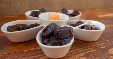Dates in a white plate close-up.