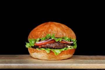 burger isolated on black background. delicious burger with beef, salad and tomatoes