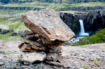 Steinformation mit Wasserfall im Hintergrund © Octavian