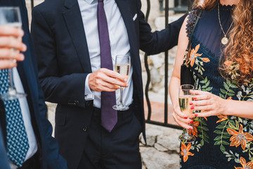 People drinking champagne or sparkling wine at a social event or party