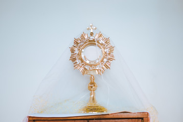 Holy eucharist on white background made of golden metal