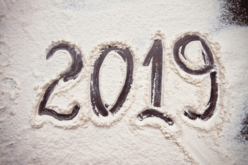 numbers 2019 of new year paint on flour table