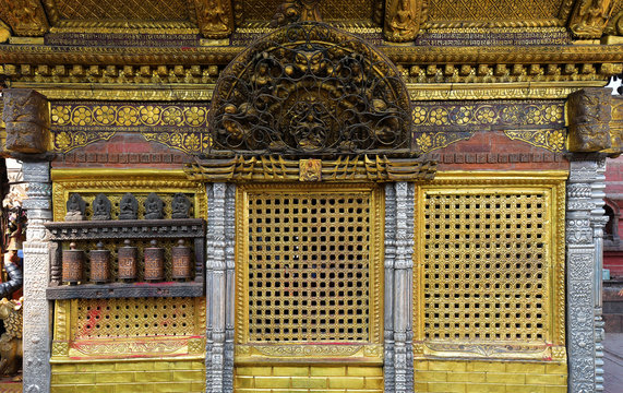 A golden pavilion with prayer wheels at Swayambhunath, Temple in in Kathmandu, Nepal