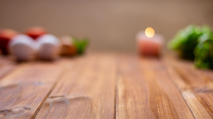 Rustic kitchen table, in the background some foods out of focus.