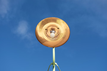 Copper large light shade lantern from victorian times retro style against blue sky view from below