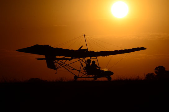 Ultralight airplane at sunset. Ultralight ride. Tranquility in flight with ultralight aircraft