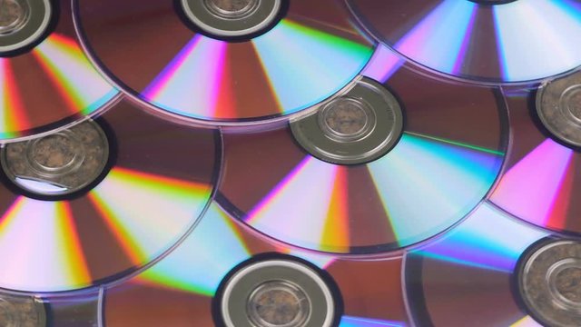 Bunch Of CD Discs Rotates Reflecting Light