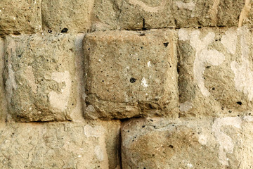 Ancient bricks of tuff. Block of tufa of an ancient Roman aqueduct.
