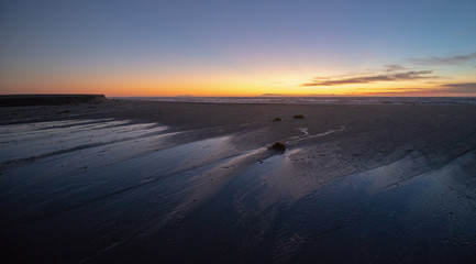 View of sunset over Santa Clara River tidal outflow to Pacific Ocean at McGrath State Park on the California Gold Coast at Ventura - United States