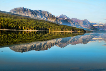 Beautiful lakes with reflections in morning light in Glacier National Park.