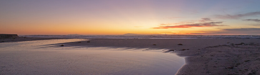 Golden sunset over Santa Clara River tidal outflow to Pacific Ocean at McGrath State Park on the California Gold Coast at Ventura - United States