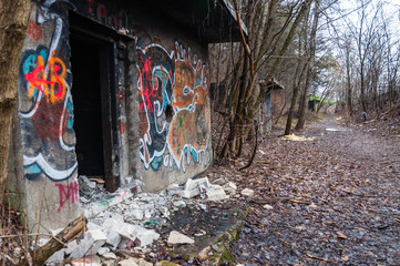 Entrance to abandoned concrete bunker built during the Second World War right in a hill near the center of Vilnius. Walls painted and decorated with graffiti