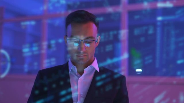 The businessman working in the dark room on the hologram background