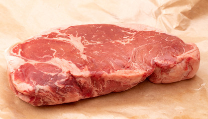 Raw New York Strip Steak on Brown Butcher Paper