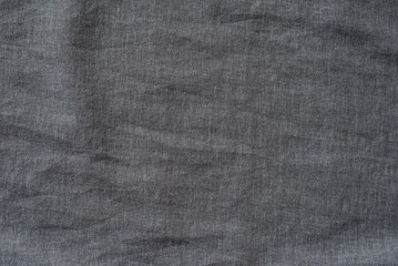 Fototapeta na wymiar Dark gray textured fabric. Close-up. Background