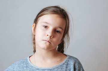 Little girl with pigtails expresses emotions of negative anger and irritation