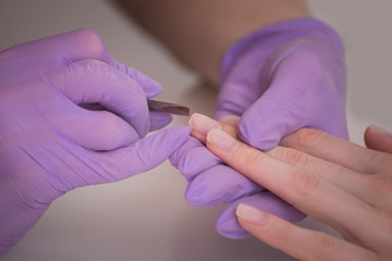 Handling nails, salon manicure. Close-up.