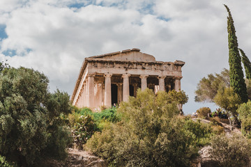 Temple of Hephaestus in Agora close-up, Athens, Greece. It is one of the main landmarks of Athens. Front view of the ancient Greek Temple of Hephaestus in summer. Historical sunny postcard of Athens.