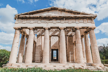Temple of Hephaestus in Agora close-up, Athens, Greece. It is one of the main landmarks of Athens. Front view of the ancient Greek Temple of Hephaestus in summer. Historical sunny postcard of Athens.