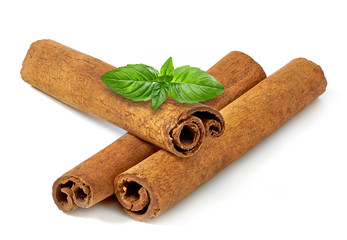 Cinnamon sticks or rolls with powder pile isolated on white background - top view