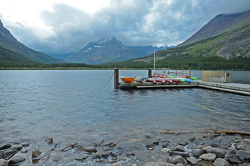 Canoe dock on a blue lake in Glacier National Park.