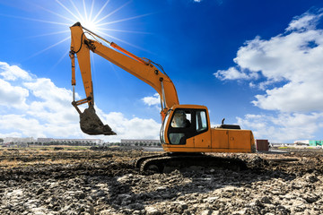 Excavator working at building site on sunny day