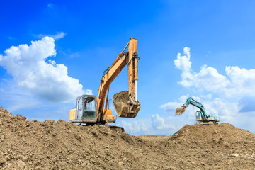 Excavator working at building site on sunny day