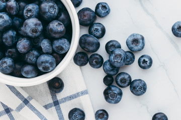 Fresh organic blueberries on a marble background