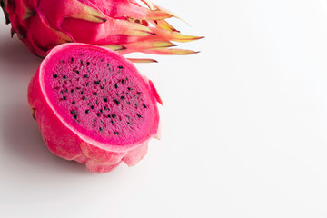 Fresh organic red dragon fruits on a white background with copy space