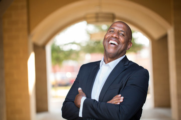 Mature African American casually dressed businessman smiling.