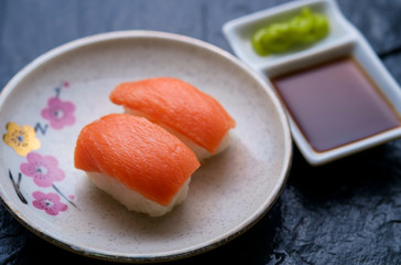 Salmon sushi serving with wasabi and soy sauce
