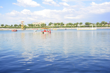 tourists ride on the pedal boats in the lake