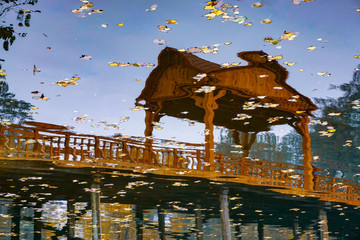 Wooden bridge over the river with a canopy. 