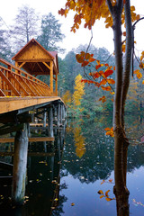 Wooden bridge over the river with a canopy. 