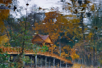 Wooden bridge over the river with a canopy. 