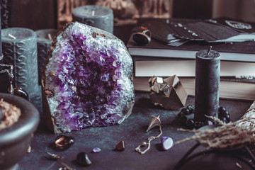 Amethyst Druze on a witch's altar for a magical ritual among crystals and black candles.