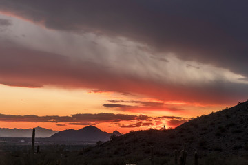 The sun setting over the mountain and the sky lights up